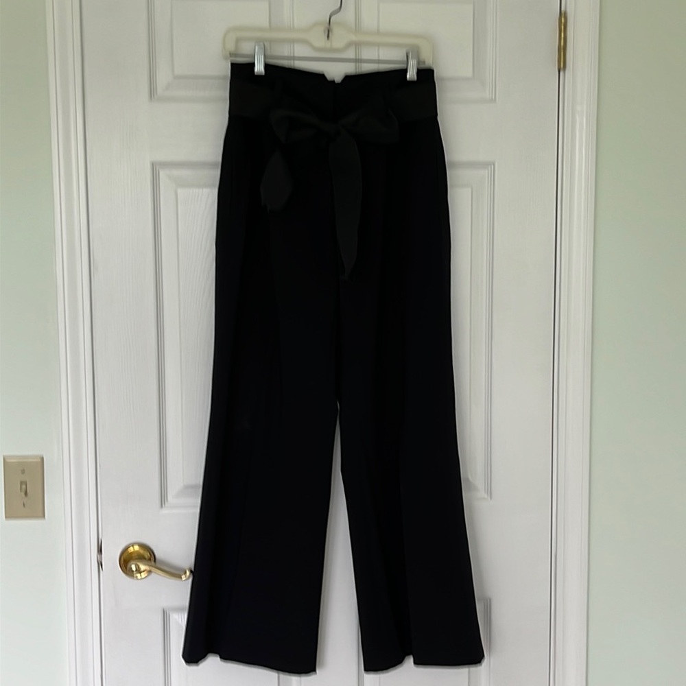CAbi black wide leg pants. Wide waist band and tie belt. Slanted front pockets.